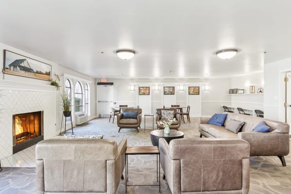Bright common area with seating and a fireplace