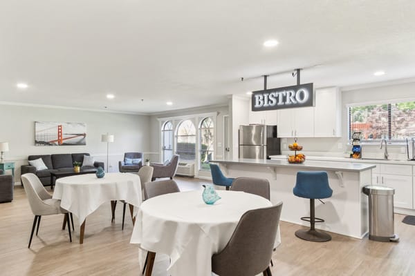 Bright bistro area with seating and kitchen