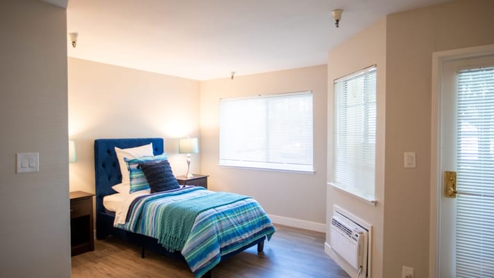 Private resident room with a bed and window