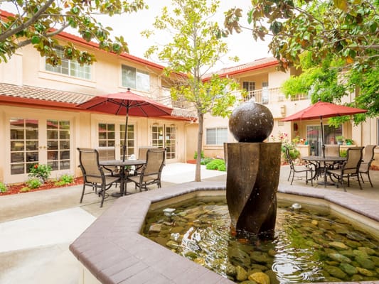 Outdoor courtyard with a fountain and seating areas