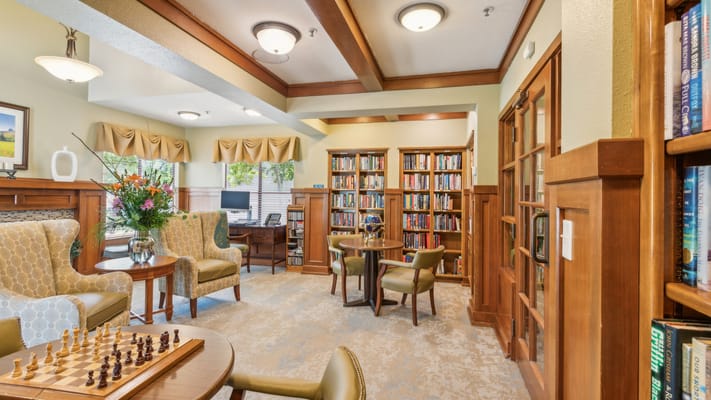 Cozy library area with comfortable seating and bookshelves