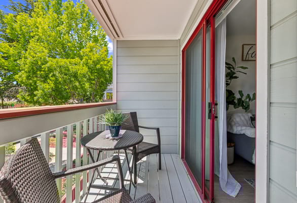 Balcony view with a small table and greenery