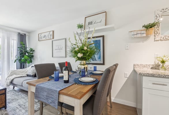 Brightly decorated dining area with a dining table and flowers