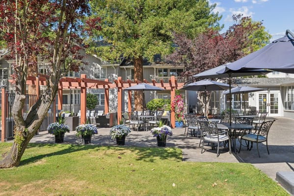 Outdoor seating area with tables and umbrellas
