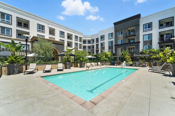 Outdoor pool surrounded by plantings and lounge chairs