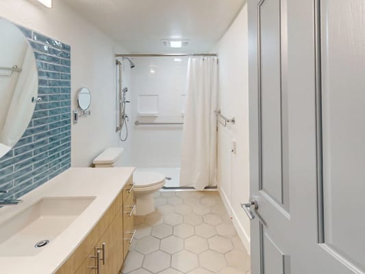 A modern, clean bathroom area with tiled shower