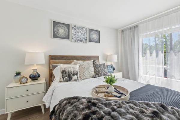 Well-decorated private resident room with bed and decor