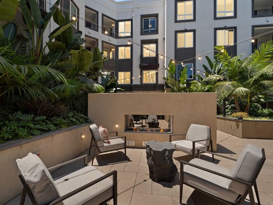 Outdoor seating area with plants and fire feature