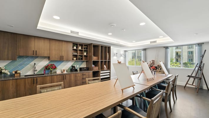 Bright community room with large tables and natural light