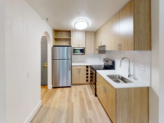 Modern kitchen interior with wooden cabinets and stainless steel appliances