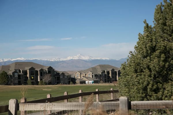 View of assisted living buildings against a mountain backdrop