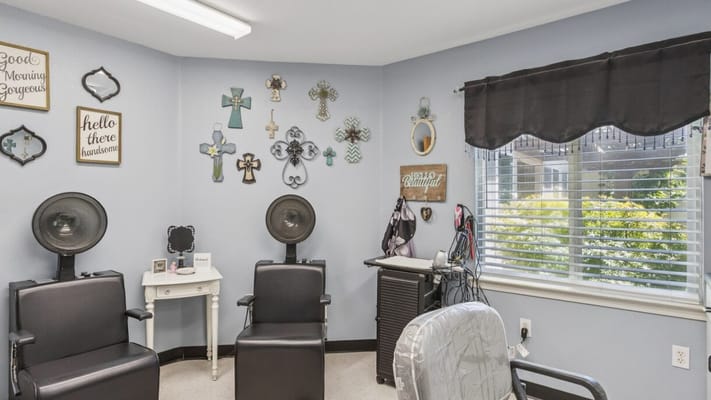 Hair salon area with styling chairs and decorations