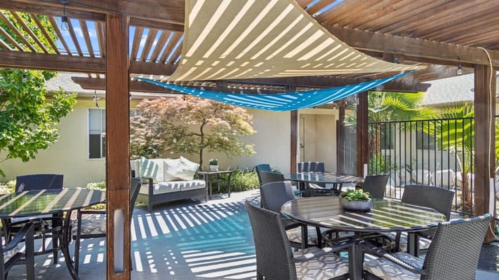 Outdoor space with tables and shaded areas