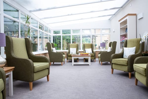 Bright and welcoming lounge area with green chairs