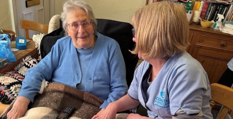A caregiver interacting with a resident indoors