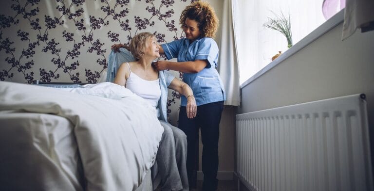 Caregiver assisting a resident in a bright room