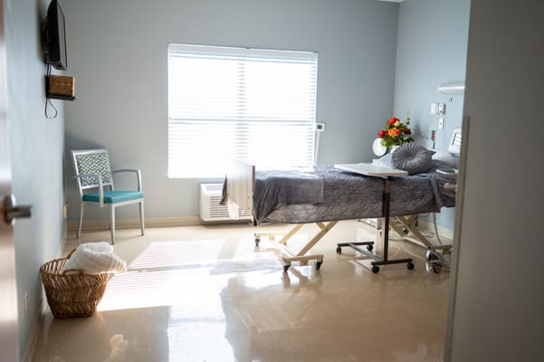 Private resident room with a bed and natural light