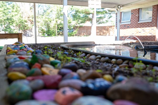 Garden area with painted rocks and water feature