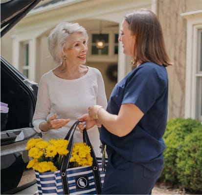 A staff member talking with a resident outdoors