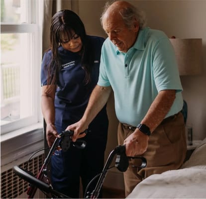 Caregiver assisting a senior man with a walker