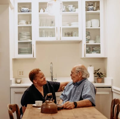 Two residents enjoying a conversation in a cozy kitchen