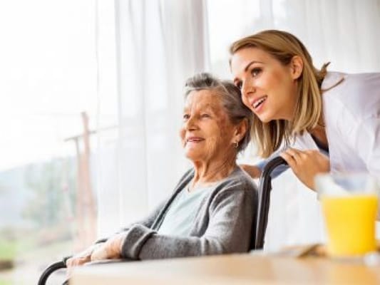 A caregiver with a resident enjoying a moment indoors