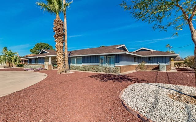 Exterior view of the assisted living facility with gardens