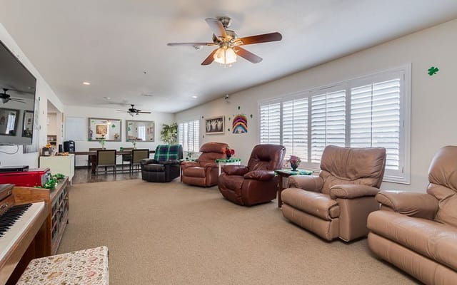 Bright common area with recliners and a piano