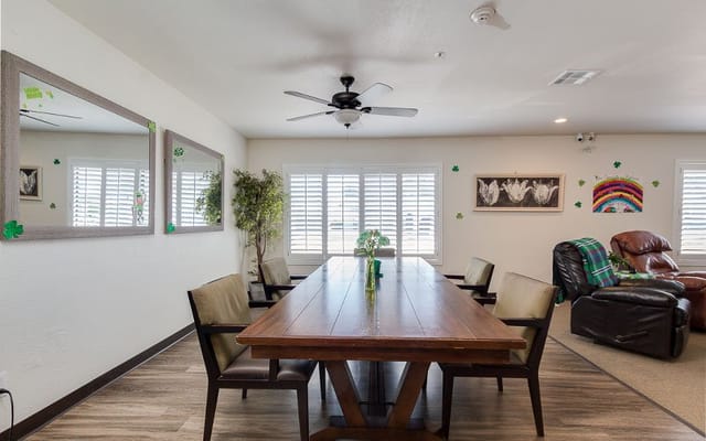 Bright common area with dining table and chairs