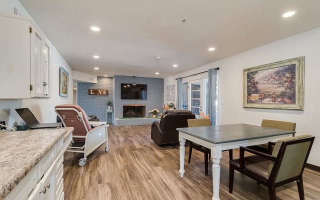 Bright common area with seating and a fireplace