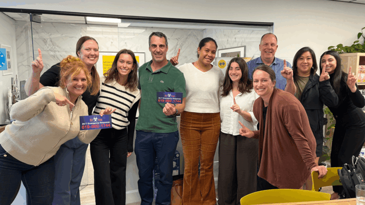 Group of smiling staff members posing together