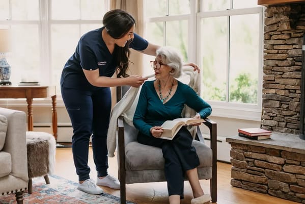 Staff assisting a resident in a cozy living area