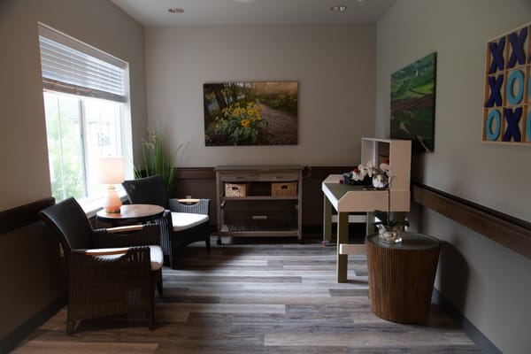 Interior seating area with decorative art and natural light