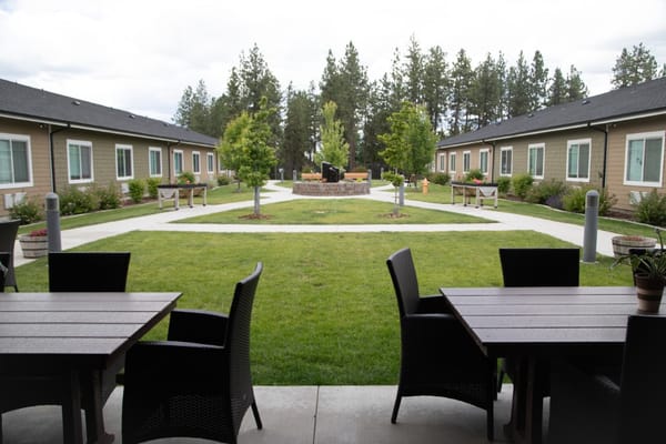 Close-up view of courtyard with tables and paths