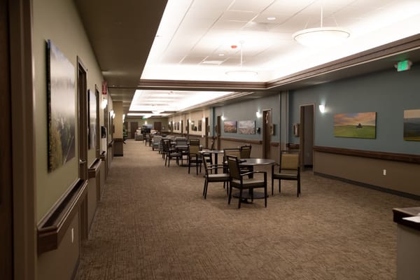 Interior hallway with seating and artwork on the walls
