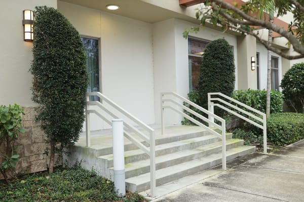 Entrance with accessible ramps and landscaping