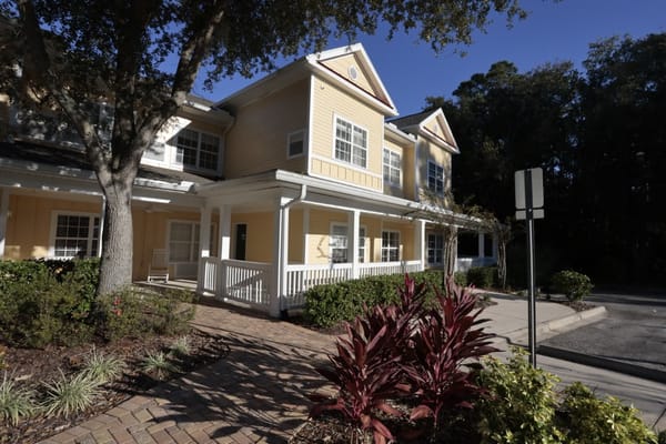 The front entrance of The Gables of Jacksonville with landscaped gardens.