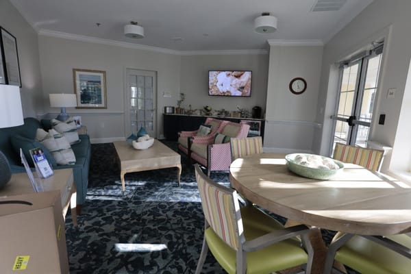 A modern lounge area with seating and a dining table.