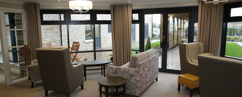 Bright common area with seating and large windows