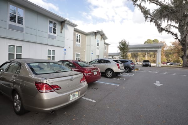 Parking area with vehicles outside the facility
