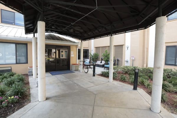 Entrance of a senior living facility with a bike
