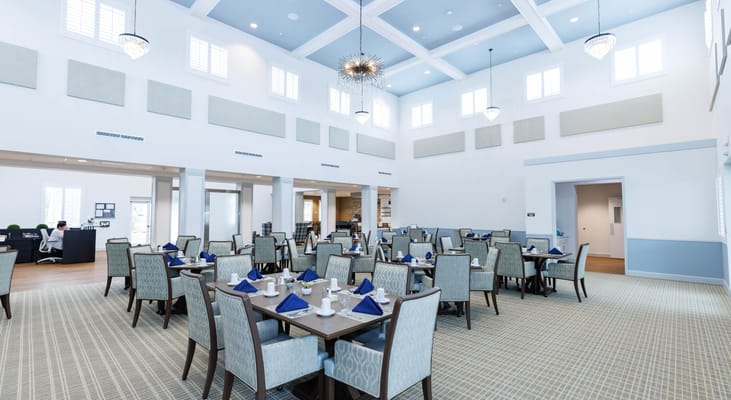 Bright dining room with tables set for meals