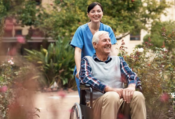 Staff member assisting a resident in a garden