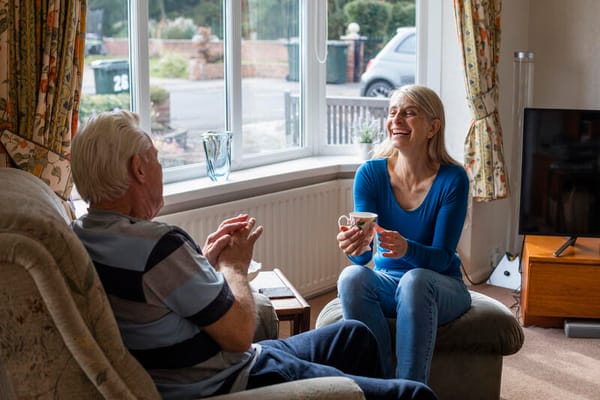 Two residents enjoying a conversation in a cozy living room