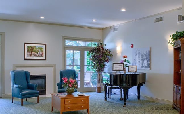 Bright common area with piano and seating