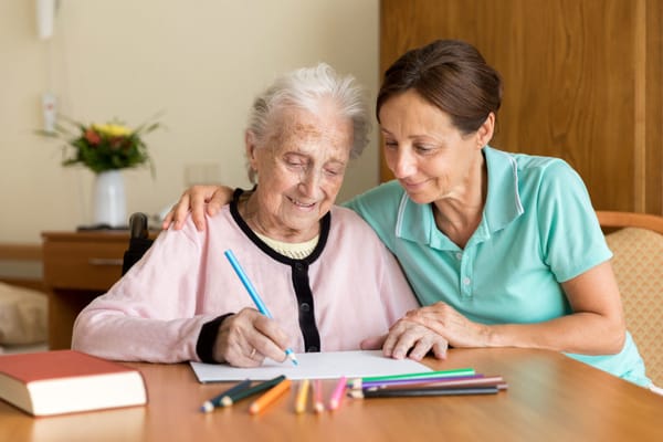 Caregiver and resident engaging in an art activity