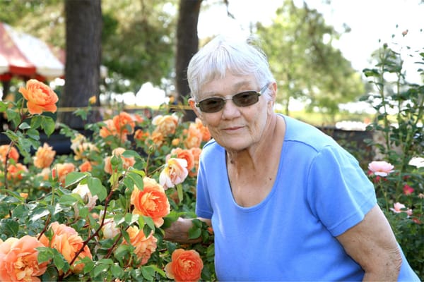Resident enjoying flowers in the garden