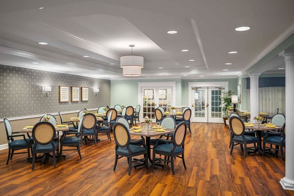 Bright dining room with tables set for meals
