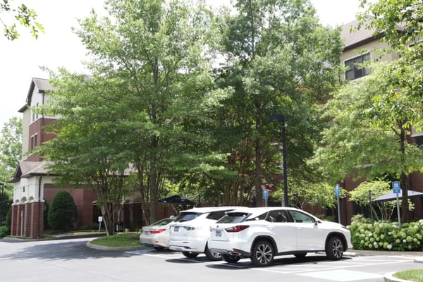 Exterior view of the facility with parked vehicles