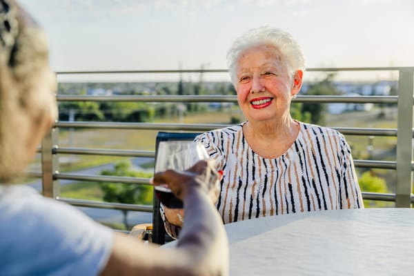 Residents enjoying drinks outdoors with a view